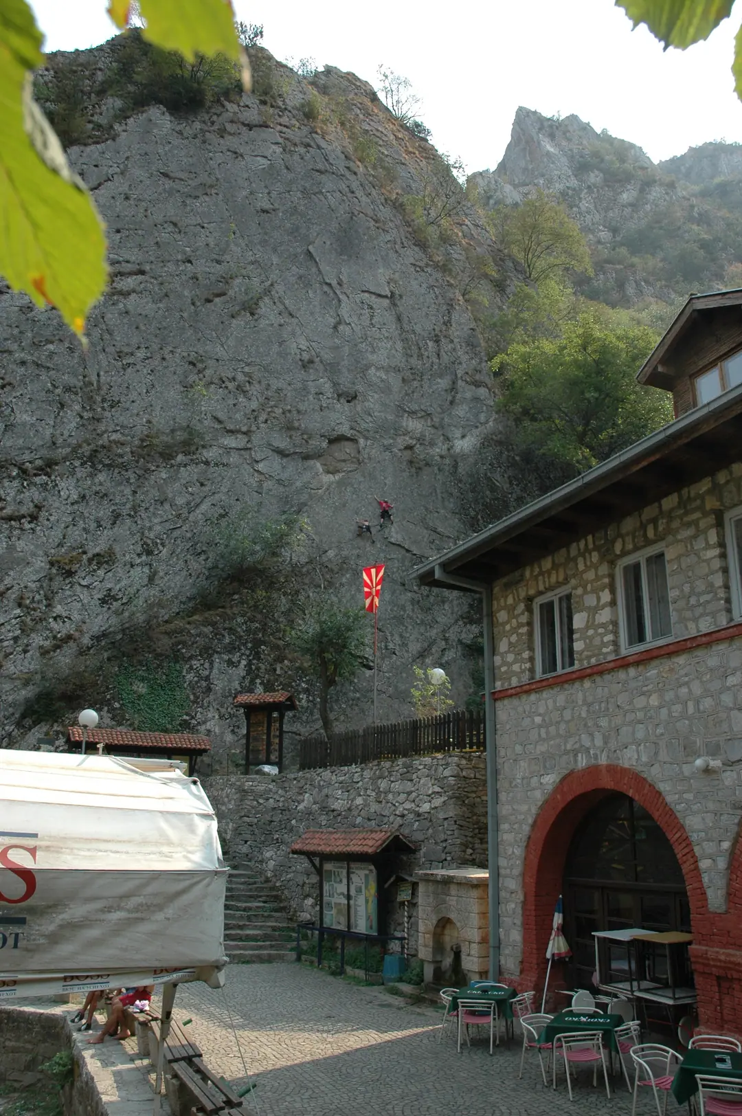 Climbers on the cliffs next to the old hotel at the Matka dam