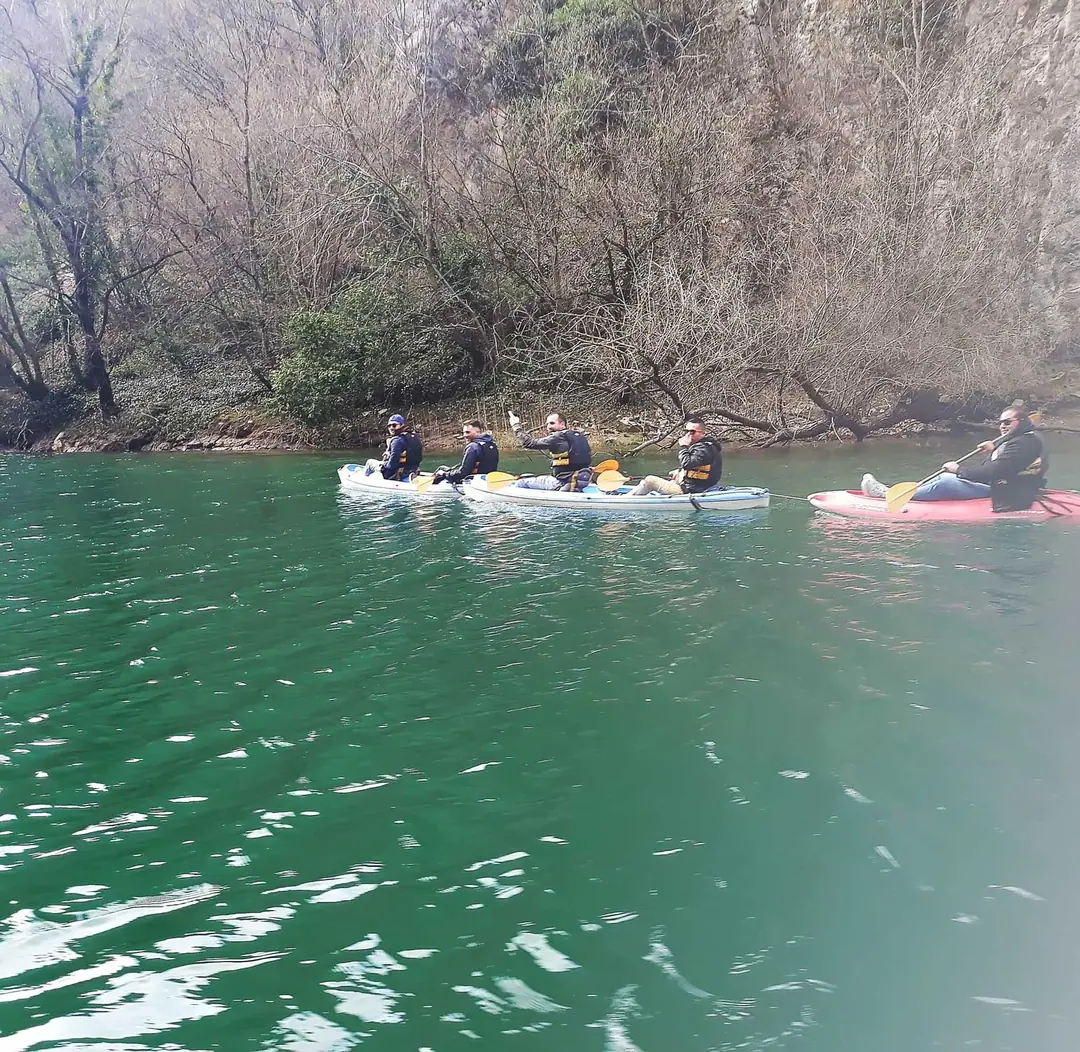 Group kayaking on the green water of Lake Matka